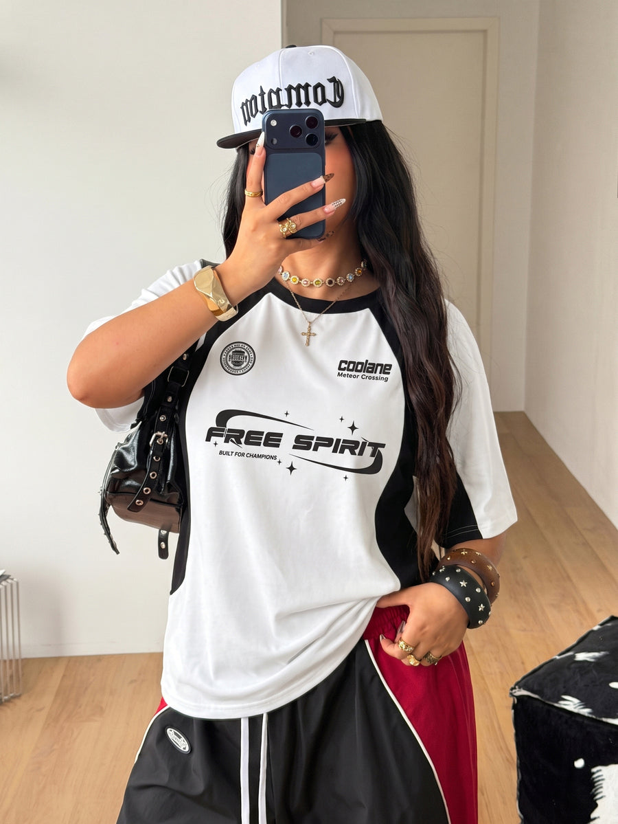 Unisex plus size oversized jersey t-shirt in brown featuring a round neck, short raglan sleeves with contrast binding, and a front letter graphic print.