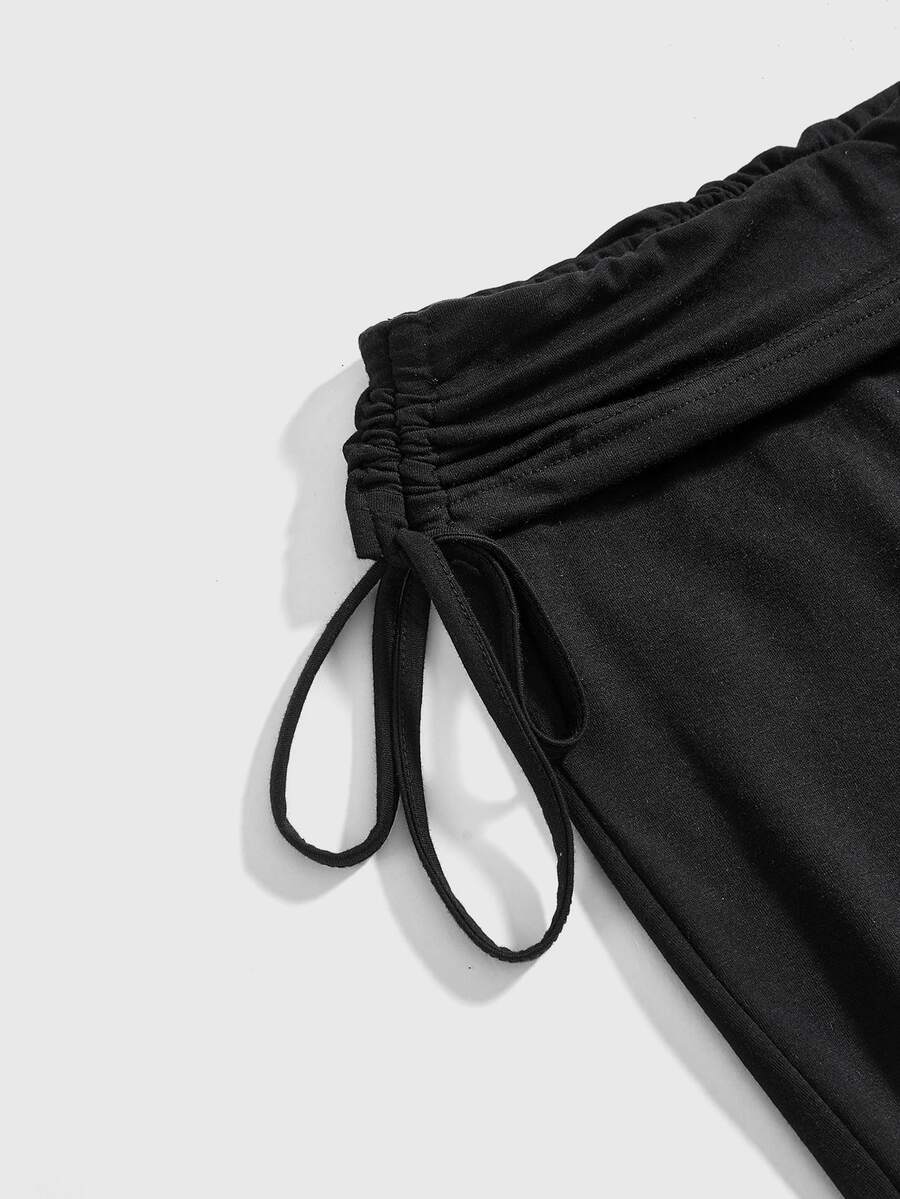 Women's low waist flare leg pants featuring an elastic drawstring waistband and ruched detail in knitted fabric.