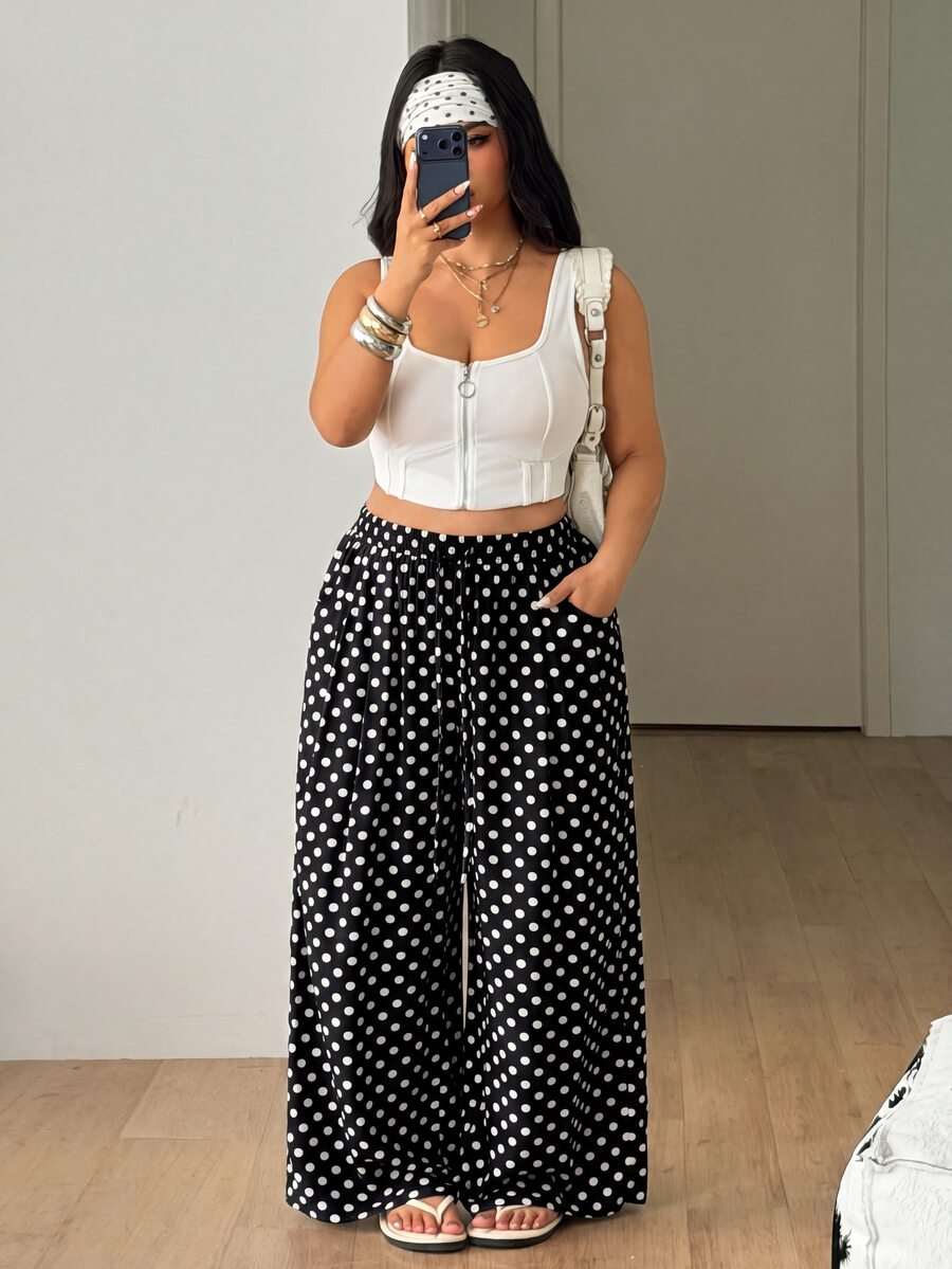 Plus size women's striped loose straight leg cropped pants with pleated detailing and side pockets