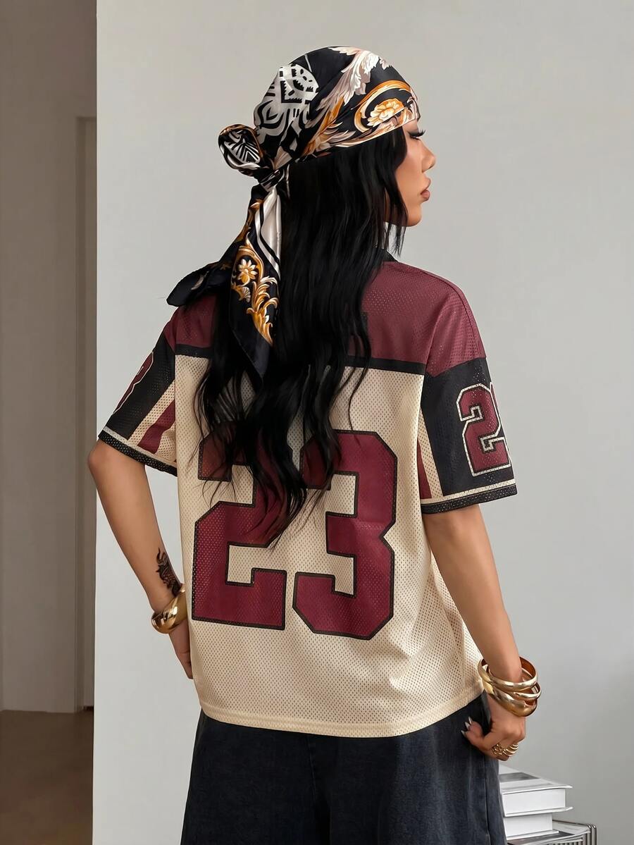 Women's oversized short sleeve graphic T-shirt with vintage digital geometric print, V-neck, and asymmetrical hem