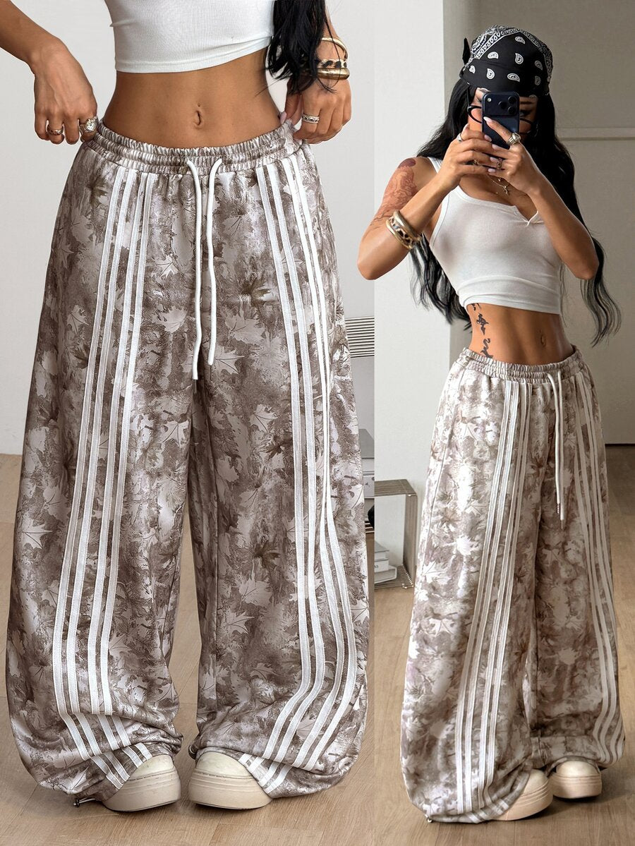 Women's loose fit wide leg graphic sweatpants in light grey with an elastic drawstring waistband
