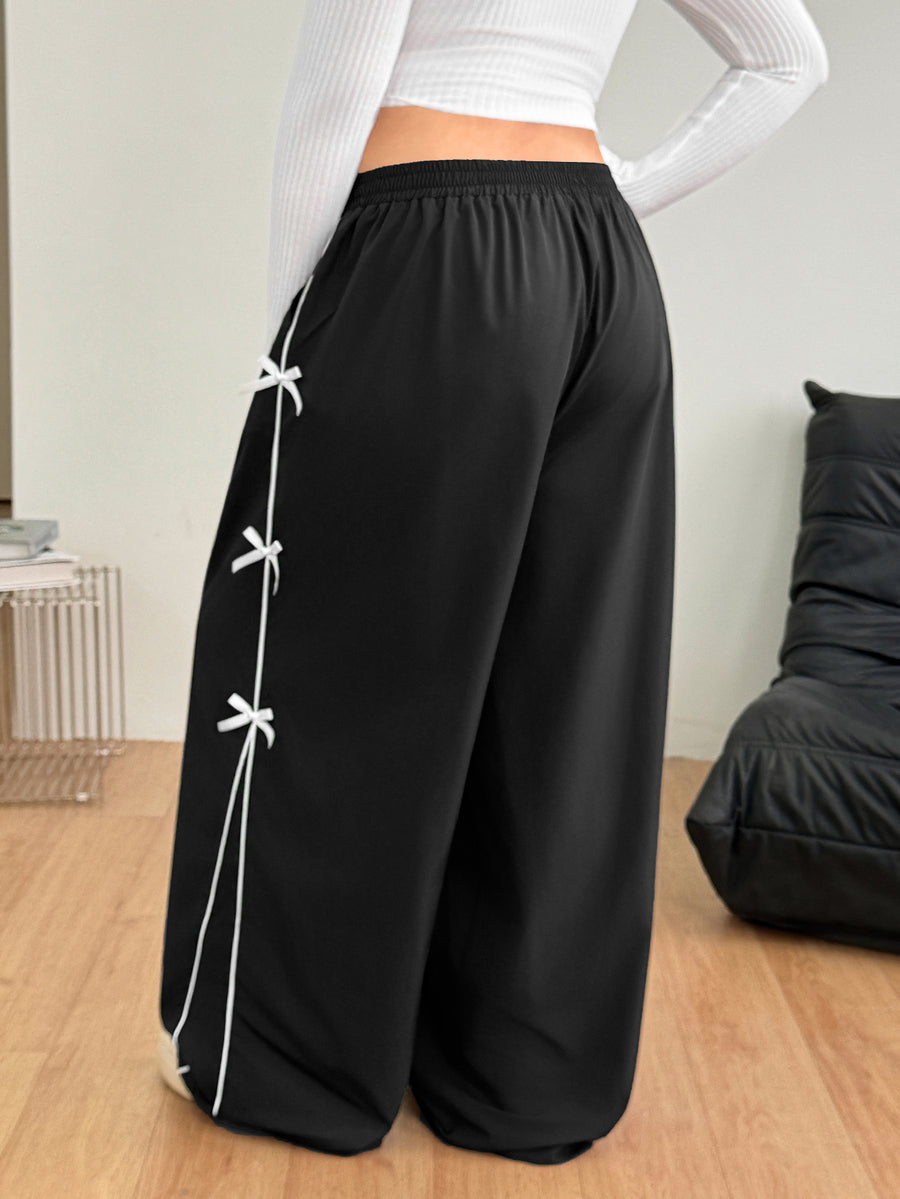 Plus size loose straight leg casual pants with elastic drawstring waist, contrast binding, and side pockets.