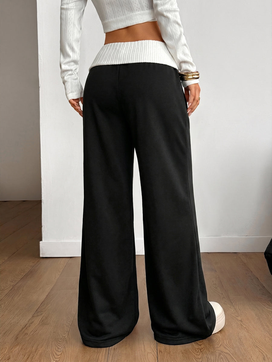 Women's wide leg flare lounge pants made of 95% cotton with a low elastic waistband and extra long hem.