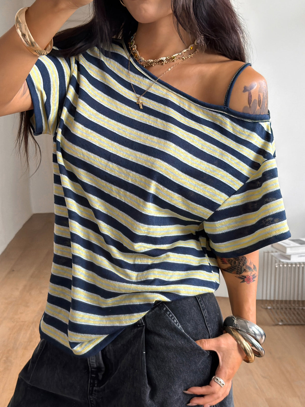 Women's casual loose fit cold shoulder cotton t-shirt with asymmetrical cutout neckline and short sleeves.