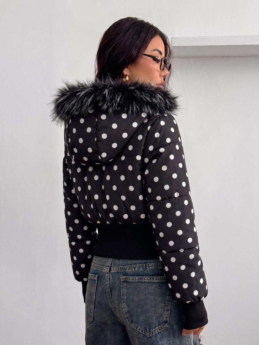 Women's brown cropped puffer jacket featuring a faux fur trimmed hood, front zipper, and ribbed hem.