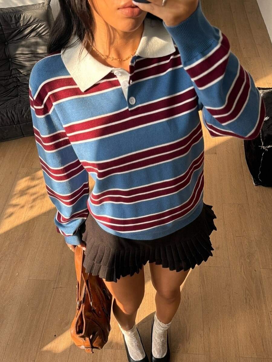 Women's blue and white striped knit polo sweater with button collar and long drop-shoulder sleeves in a relaxed fit.