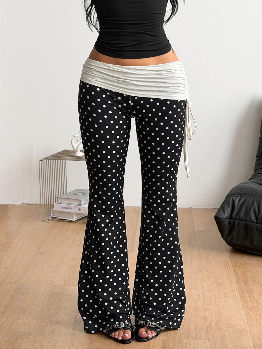 Women's black and white polka dot flare leg pants with side drawstring and ruched details