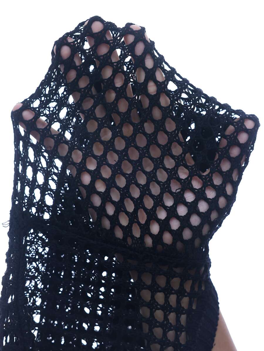 Front view of a women's black hollow out knit cover up sweater featuring flare long sleeves and a micro cropped asymmetrical hem.