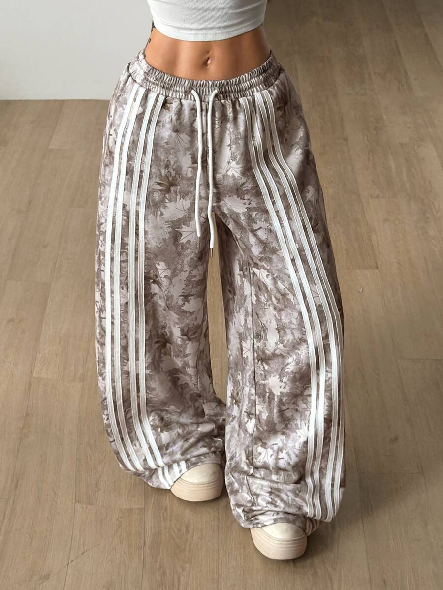 Women's loose fit wide leg graphic sweatpants in light grey with an elastic drawstring waistband