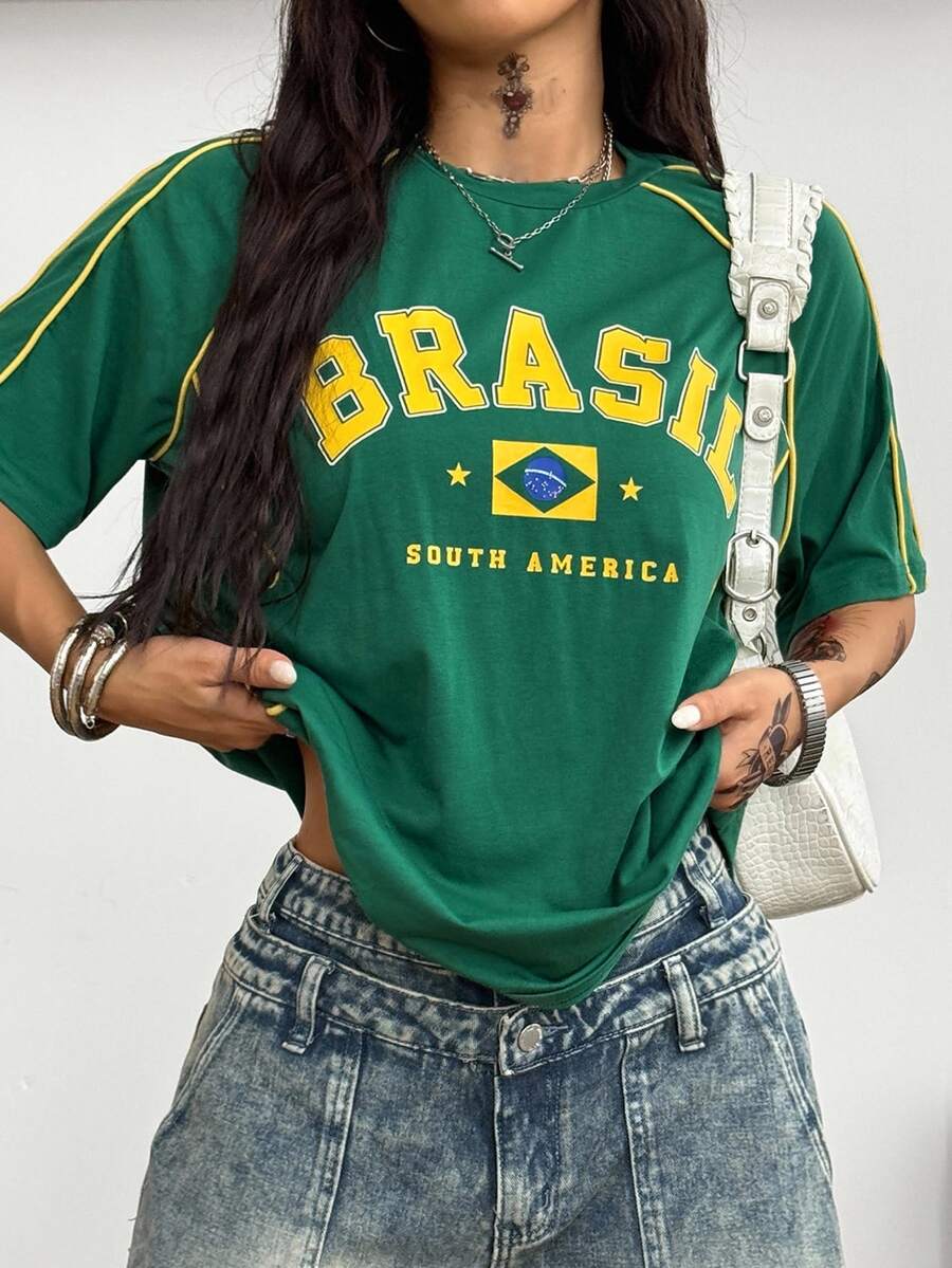 Yellow oversized graphic t-shirt featuring Brazil letter print on the front with contrast raglan sleeves and side stripe detailing.