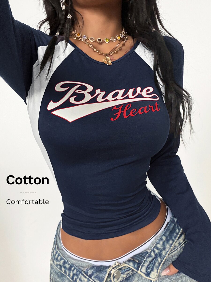 Women's slim fit long sleeve raglan t-shirt with collegiate letter graphic print, round neck, and contrast binding.