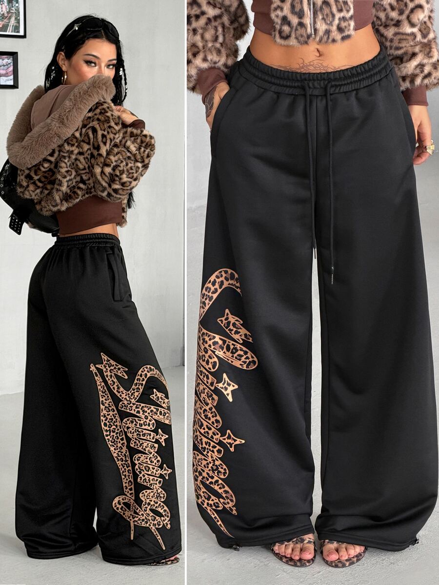 Women's loose fit wide leg graphic sweatpants in light grey with an elastic drawstring waistband