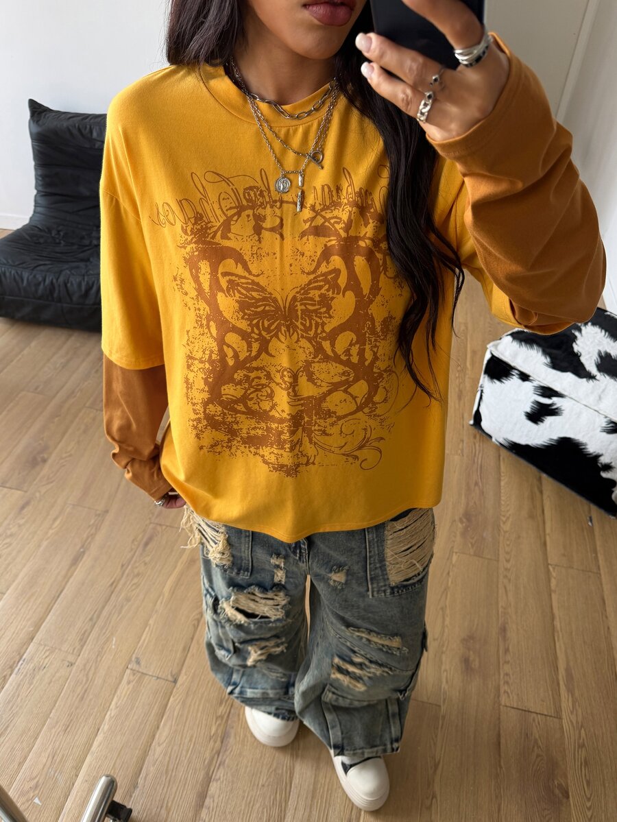 Women's casual graphic long sleeve t-shirt with a round neck, drop shoulder sleeves, and loose relaxed fit.