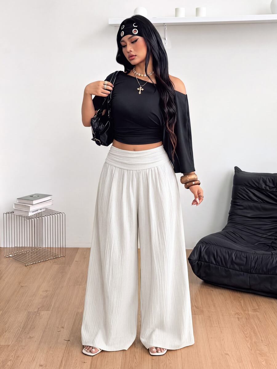 Women's plus size high-waist pleated wide leg pants in textured woven fabric with pockets