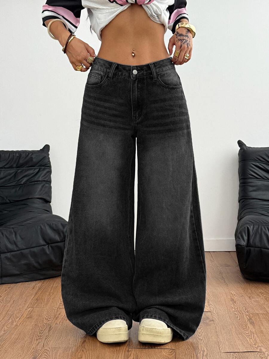 Loose wide leg denim jeans for women featuring a low waist, functional pockets, zipper fly closure, and extra long relaxed fit.
