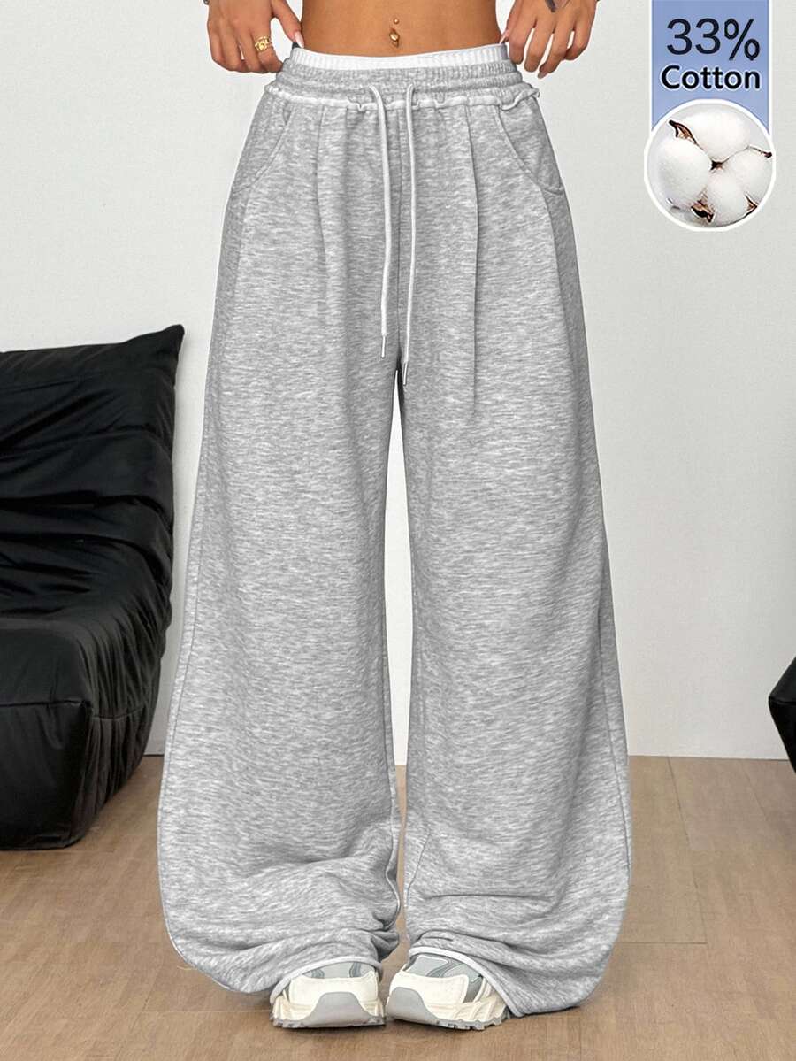 Women's casual straight leg baggy lounge pants in light grey with an adjustable drawstring waist and side pockets.