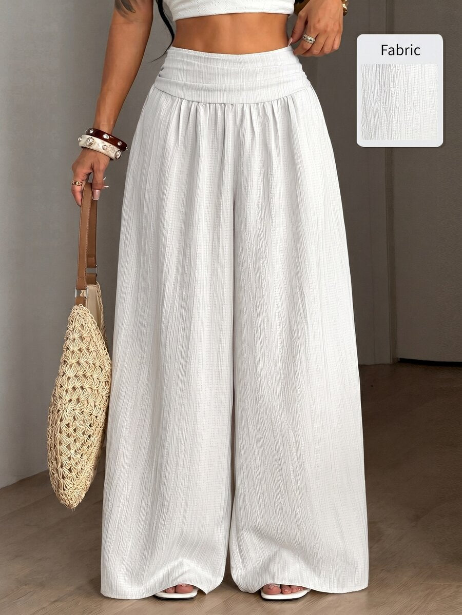 Women's plus size high-waist pleated wide leg pants in textured woven fabric with pockets