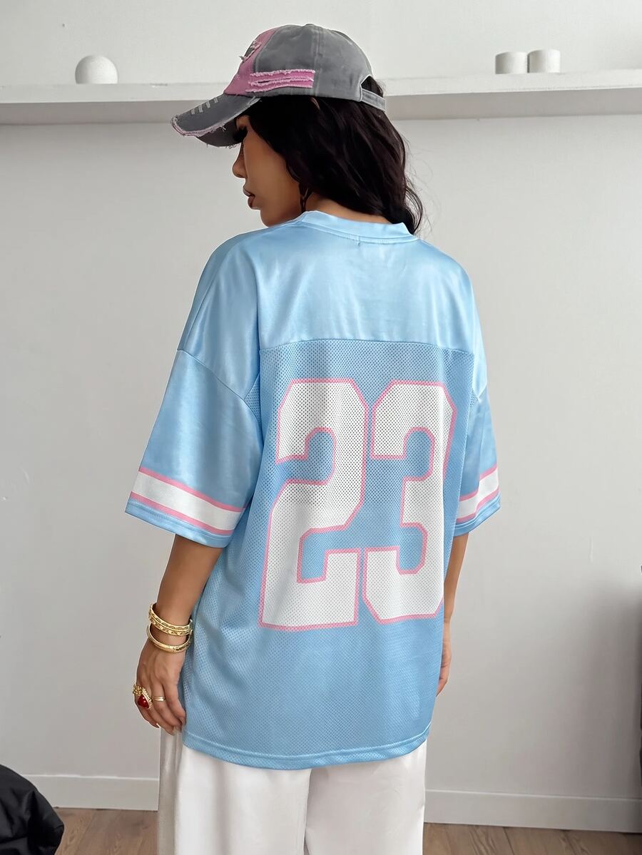 Oversized short-sleeve football jersey top featuring a V-neckline, contrast binding, and graphic number print.