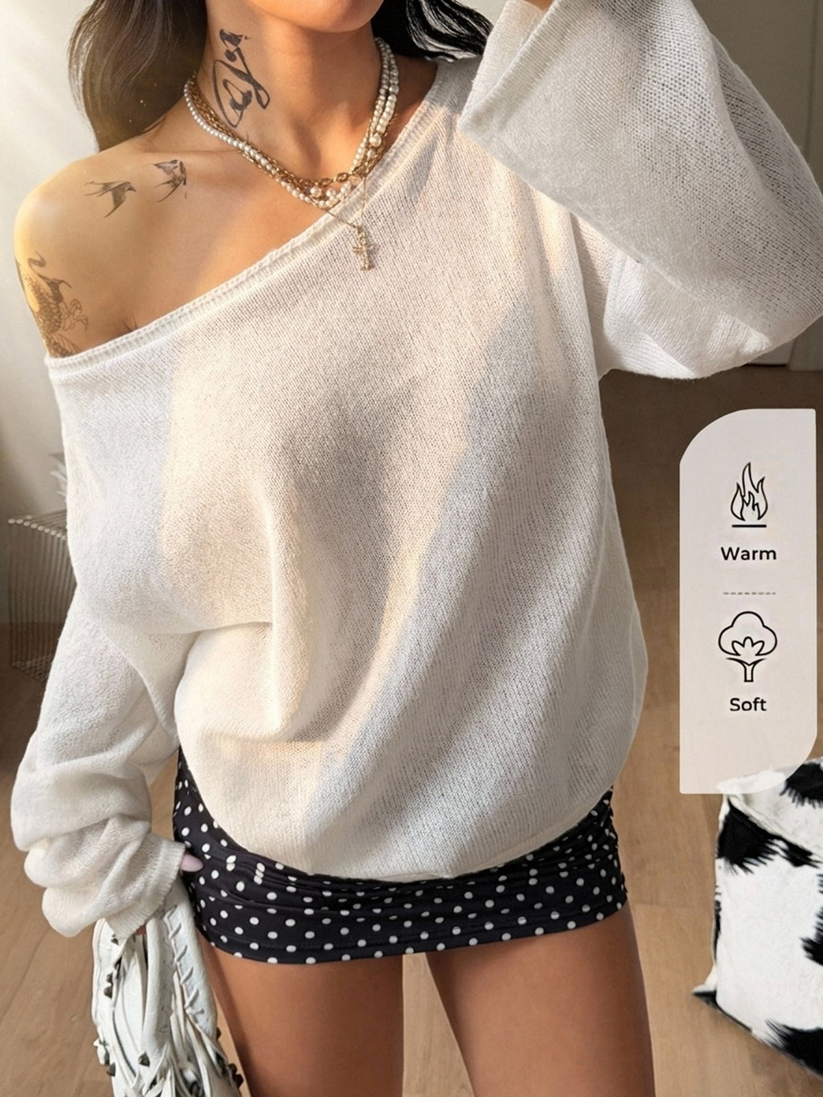 White cold shoulder sweater for women featuring a loose fit, asymmetrical neckline, raglan sleeves, and rib-knit texture.