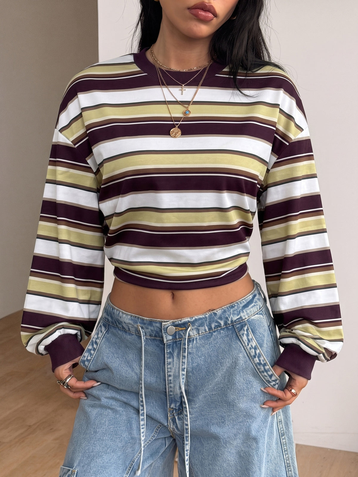 Women's striped pullover sweatshirt featuring drop shoulder long sleeves and a classic round neckline.