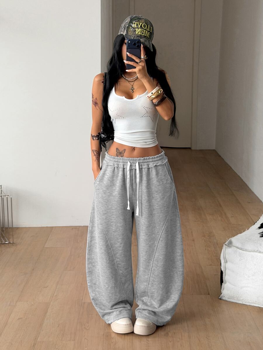 Women's casual grey plaid sweatpants featuring an elastic drawstring waistband, side pockets, and a relaxed loose fit.