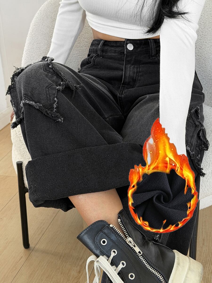 Front view of women's loose wide leg denim jeans featuring a mid waist, classic front pockets, and a zipper fly closure.