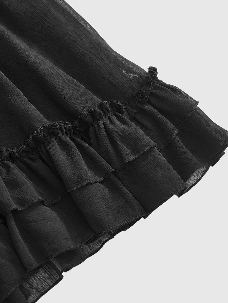 Front view of a black goth cami mini dress featuring cold shoulder spaghetti straps, chiffon fabric, and a tiered ruffle flounce hem.