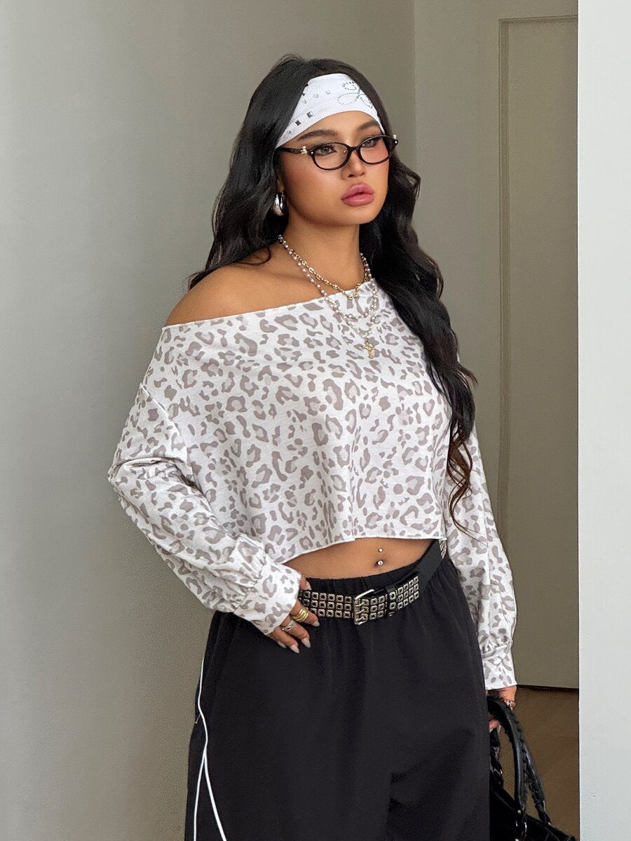 Plus size women's cropped leopard print sweatshirt featuring an asymmetrical neckline and long drop-shoulder sleeves.