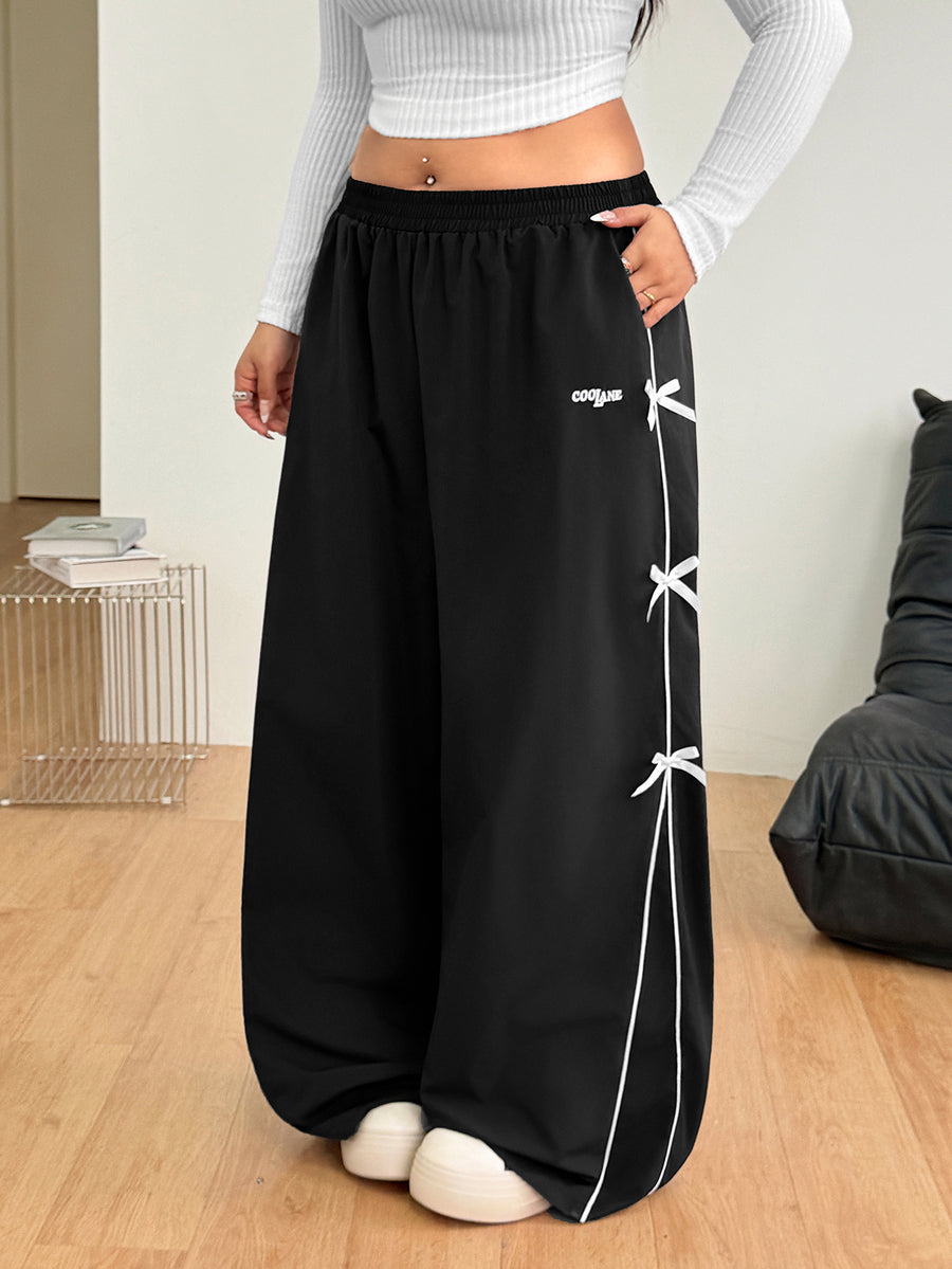 Plus size loose straight leg casual pants with elastic drawstring waist, contrast binding, and side pockets.
