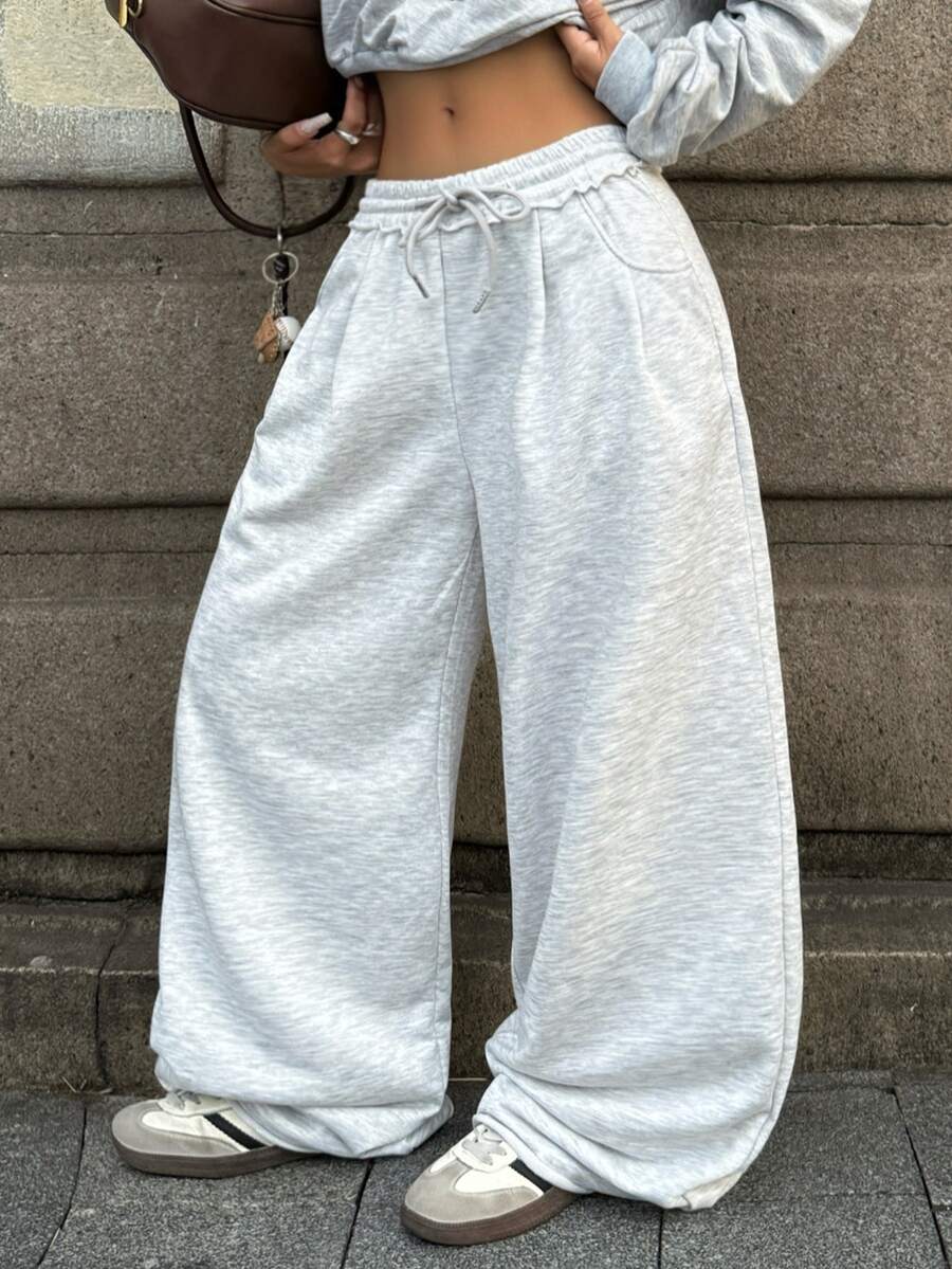 Women's casual straight leg baggy lounge pants in light grey with an adjustable drawstring waist and side pockets.