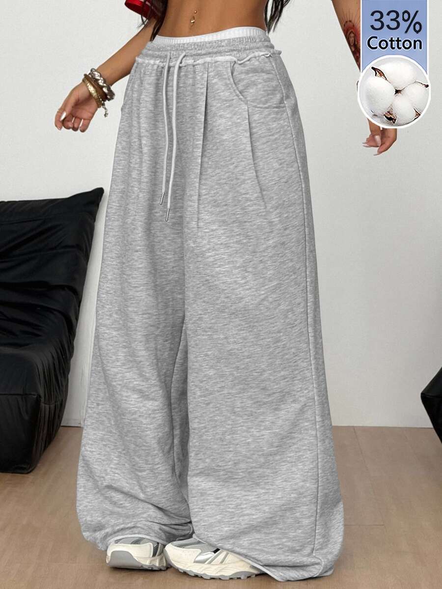 Women's casual straight leg baggy lounge pants in light grey with an adjustable drawstring waist and side pockets.