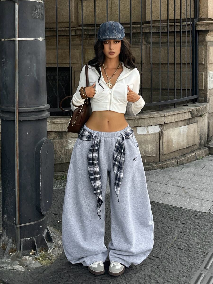 Women's casual grey plaid sweatpants featuring an elastic drawstring waistband, side pockets, and a relaxed loose fit.