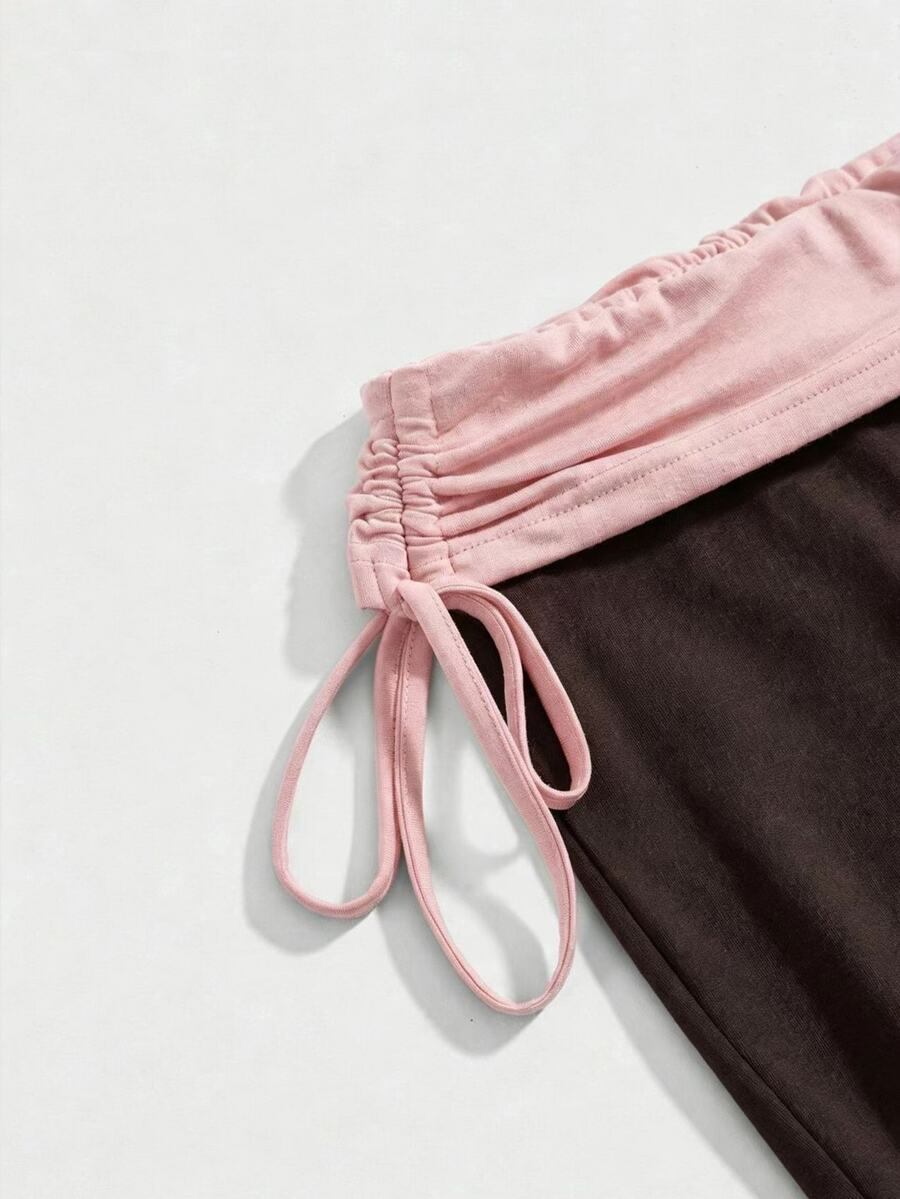 Women's low waist flare leg pants featuring an elastic drawstring waistband and ruched detail in knitted fabric.