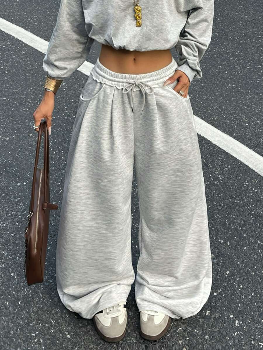 Women's casual straight leg baggy lounge pants in light grey with an adjustable drawstring waist and side pockets.