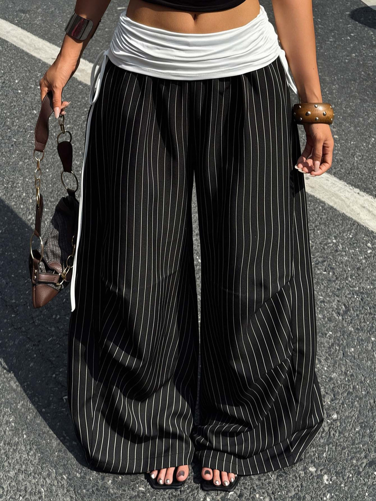 Women's loose fit wide leg jogger pants in black with white drawstring tie detail and elastic waistband.