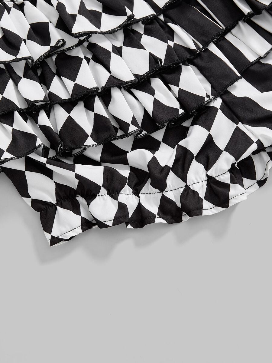 Black and white striped and geometric patchwork gothic pumpkin shorts for women featuring tiered ruffle hems and an elastic waistband.