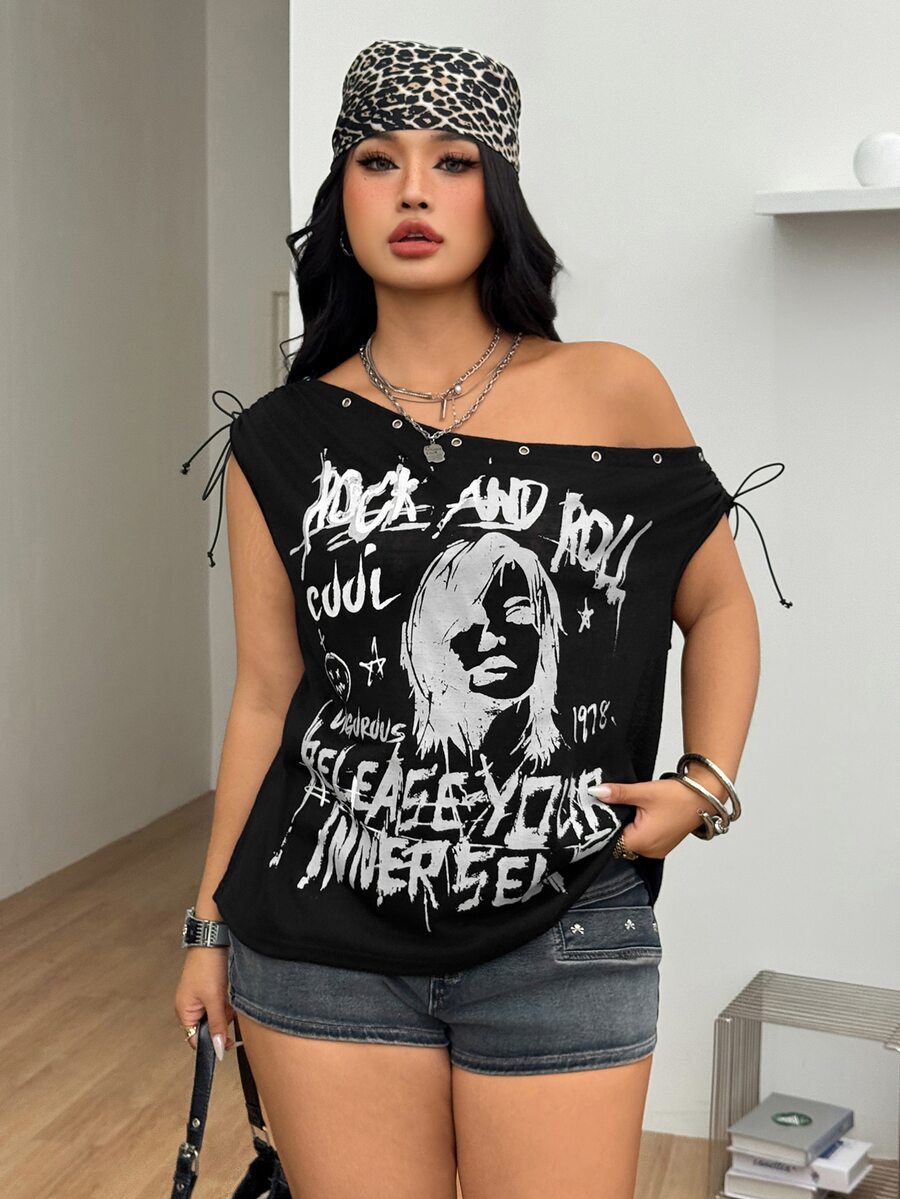 Black plus size cold shoulder graphic T-shirt featuring grommet eyelets, asymmetrical knot detail, and batwing cap sleeves.