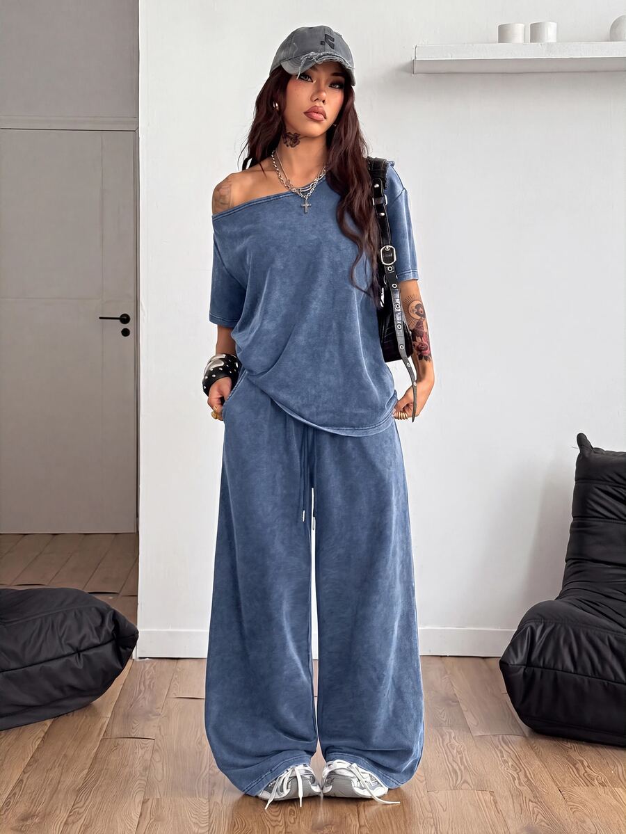 Women's two-piece outfit featuring an oversized asymmetrical neck t-shirt and matching wide-leg drawstring sweatpants.