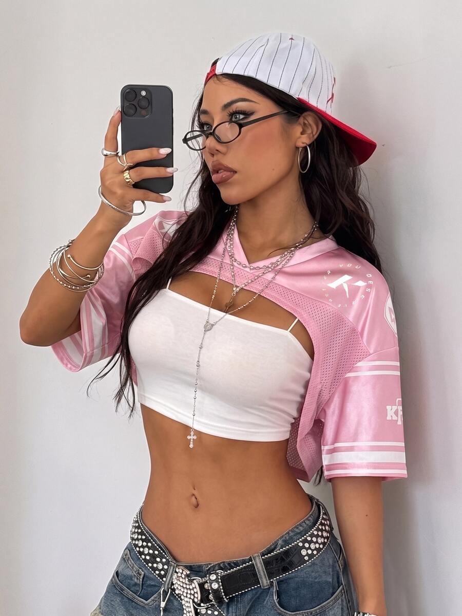 Front view of a women's black and white striped short sleeve crop top with a round neckline and semi-sheer knit finish.