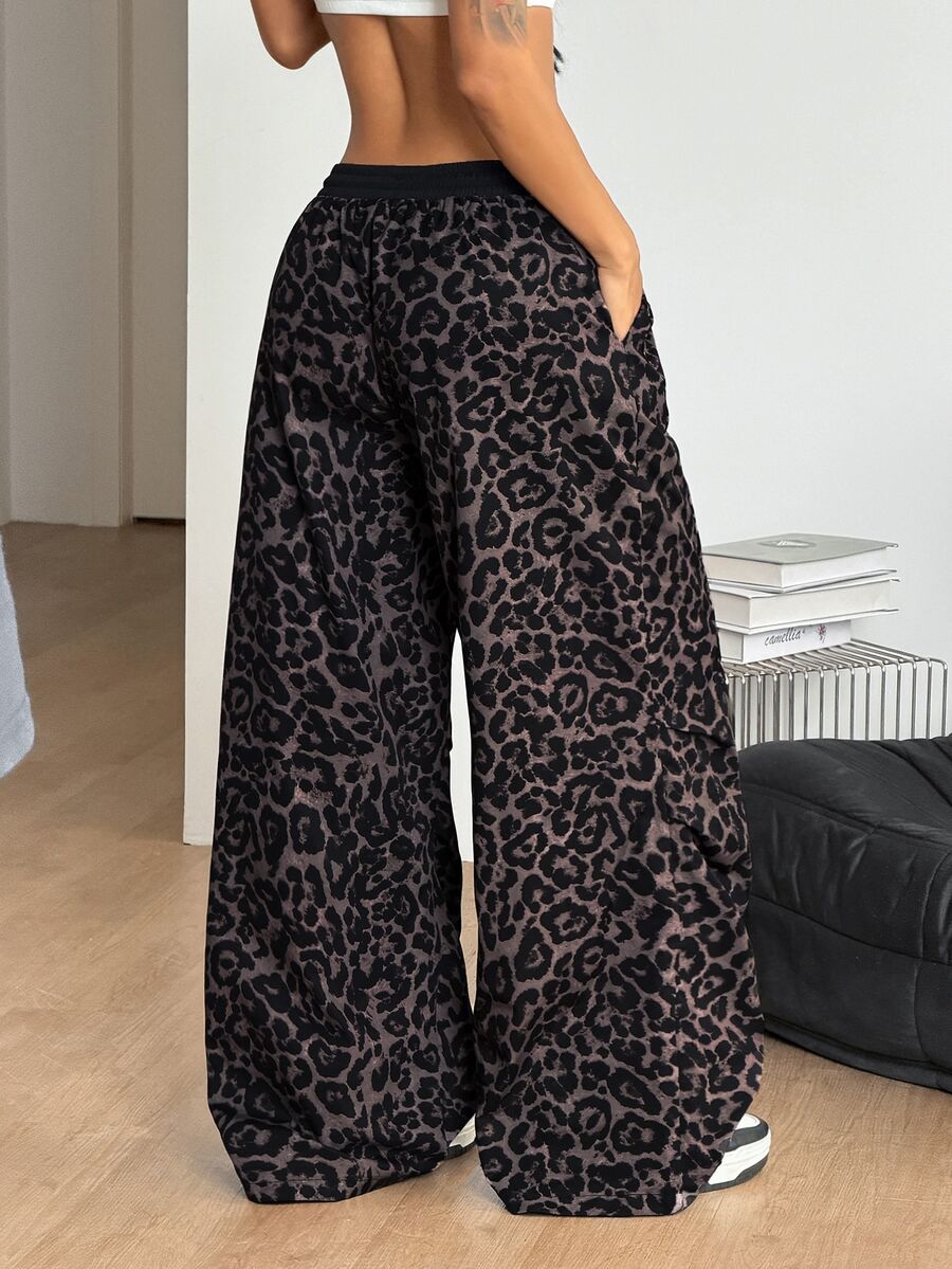 Women's black baggy jogger pants with an adjustable drawstring waist and colorblock polka dot geometric pattern.