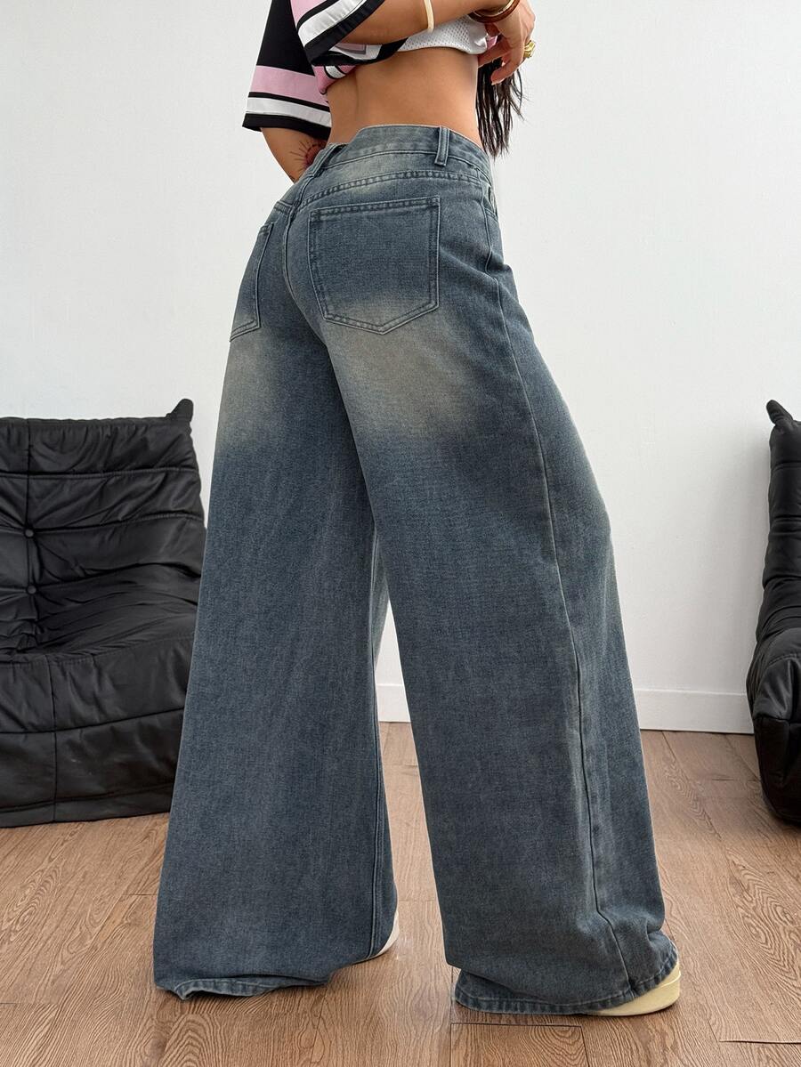 Loose wide leg denim jeans for women featuring a low waist, functional pockets, zipper fly closure, and extra long relaxed fit.