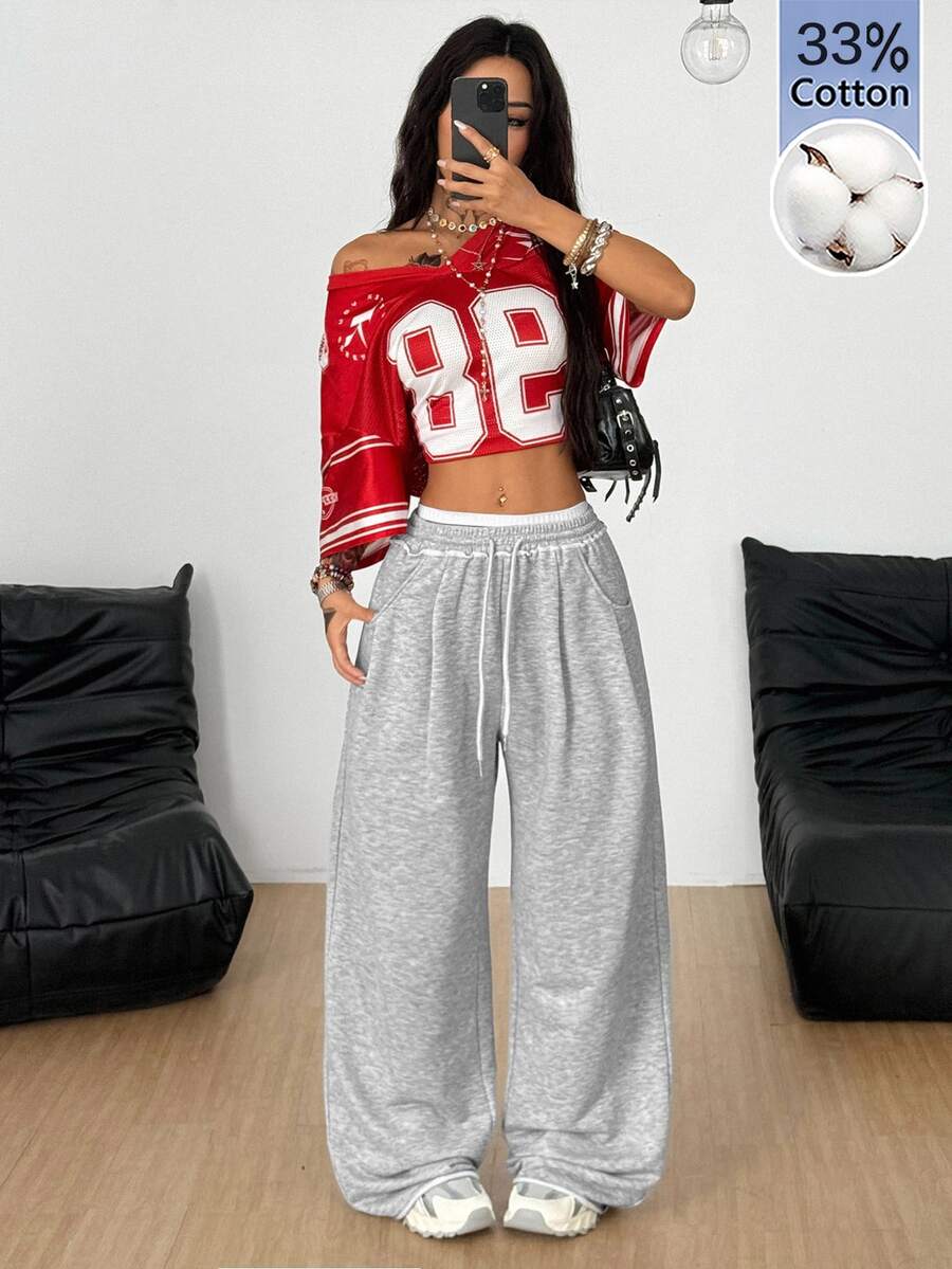 Women's casual straight leg baggy lounge pants in light grey with an adjustable drawstring waist and side pockets.