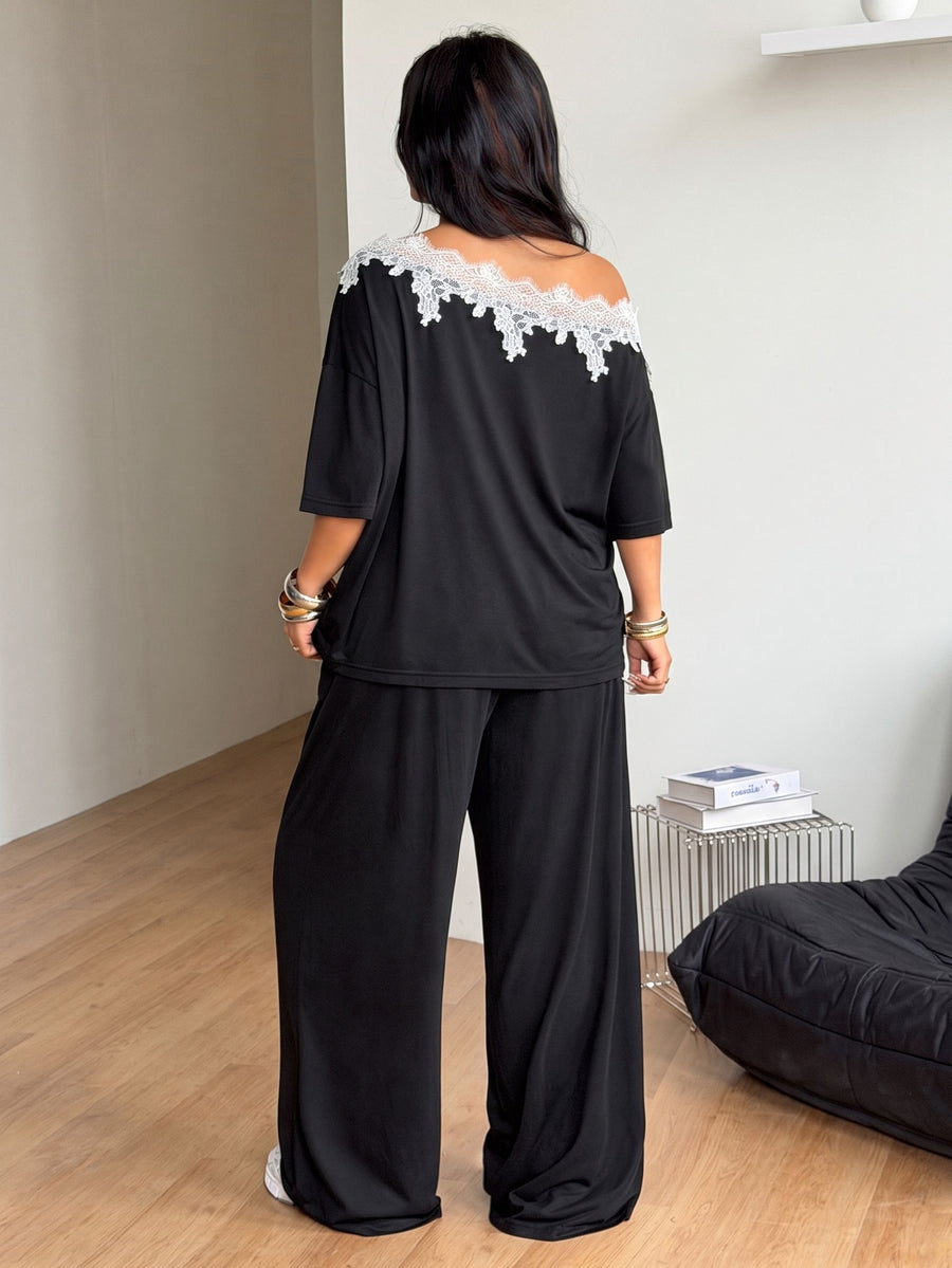 Women's casual two-piece outfit featuring a loose short-sleeve asymmetrical neck t-shirt and matching long wide leg pants with pockets.