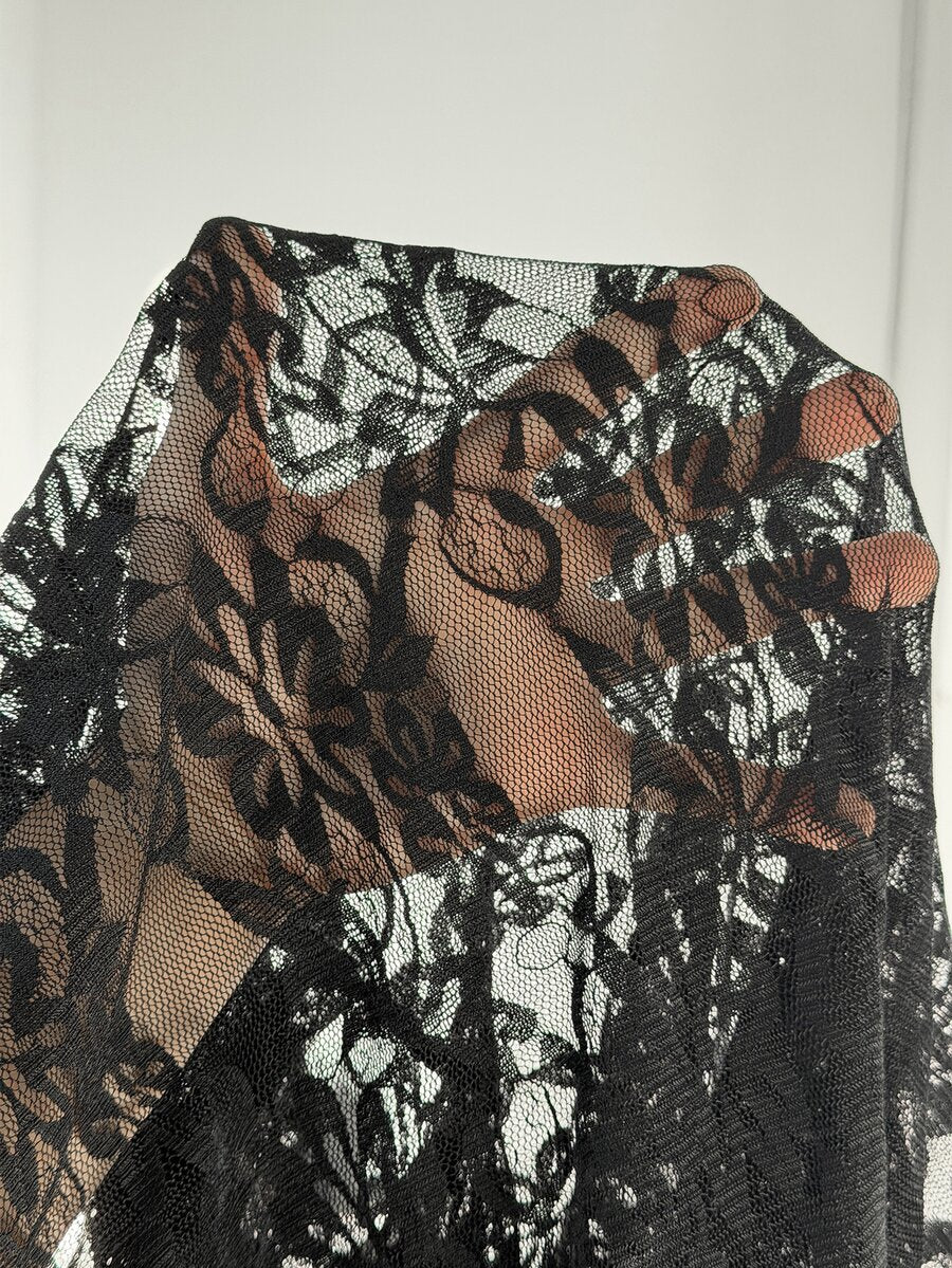 Black high-waist flare leg pants featuring contrast lace trim, floral ribbon detail, and semi-sheer knitted fabric.