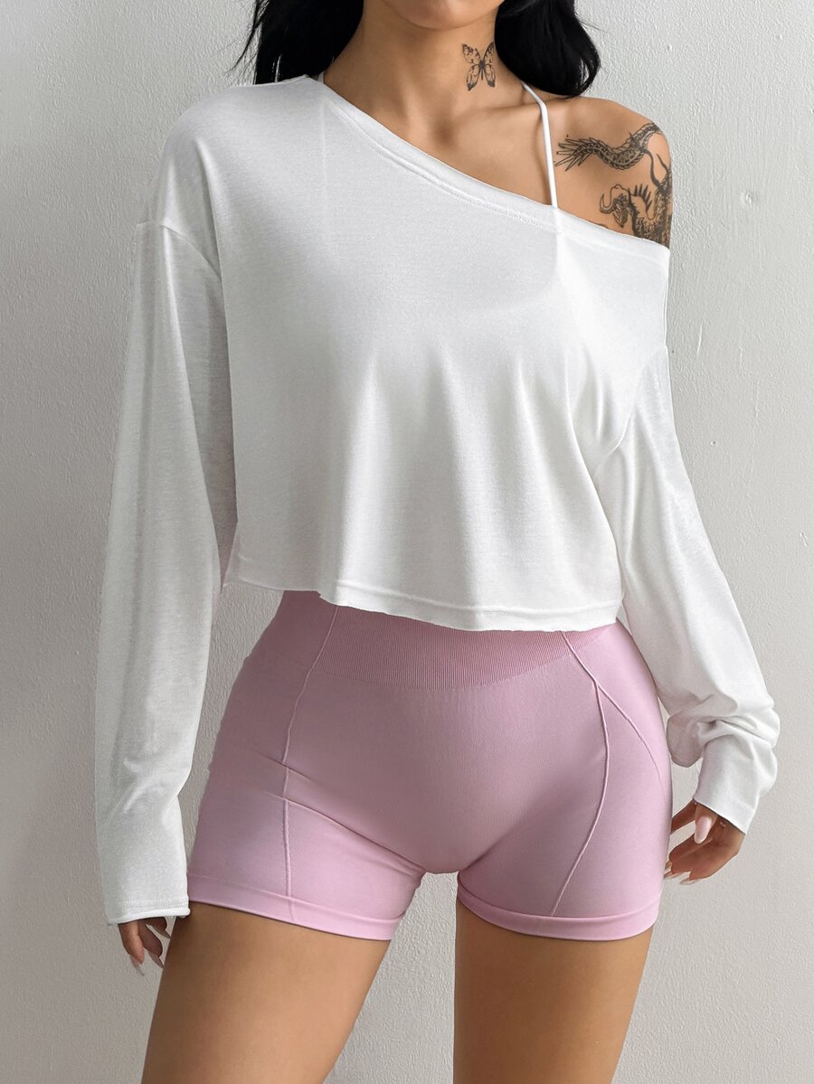 Women's white one shoulder rib-knit crop pullover top featuring an asymmetrical neckline, drop shoulder long sleeves, and a relaxed loose fit for yoga and athleisure wear.