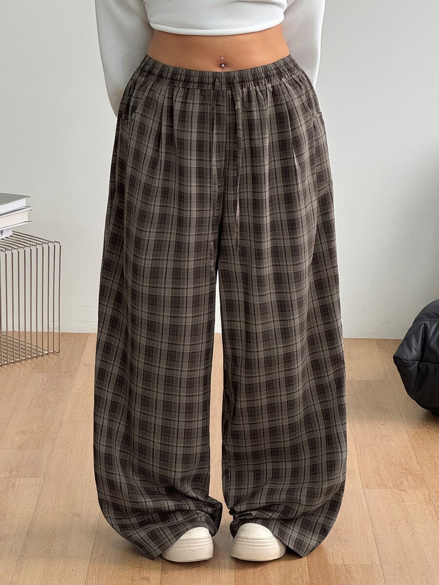 Women's loose straight leg cotton pants featuring a high waist with an adjustable drawstring knot and functional side pockets.