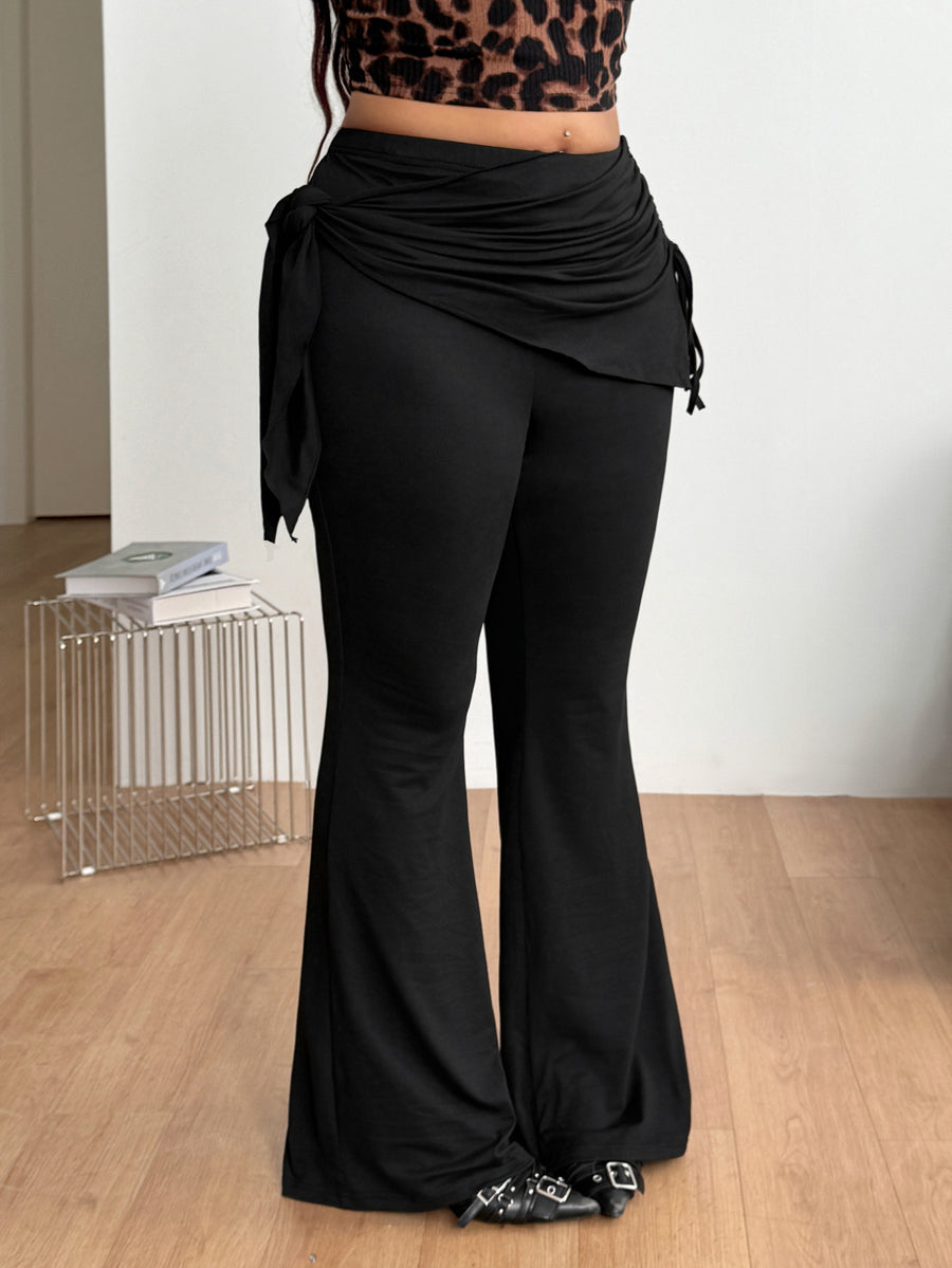 Women's striped flare leg pants featuring a mid-rise waist, slim fit thigh, and ruched side drawstring detail in stretch knit fabric.