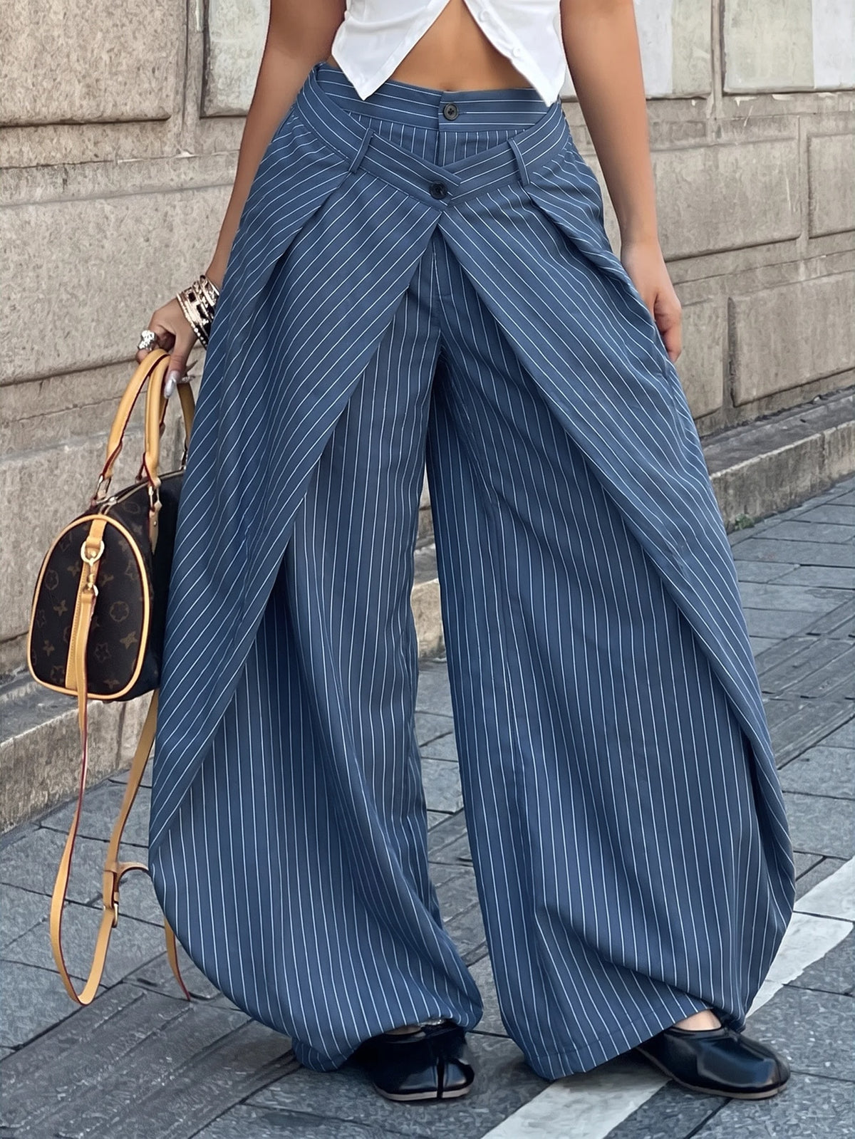 Women's loose fit pleated wide leg pants in royal blue pinstripe woven fabric with zipper fly closure.