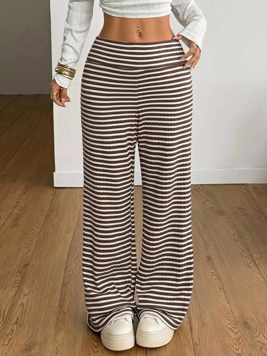 Women's casual straight leg sweatpants featuring a black and white polka dot design with an elastic waistband.