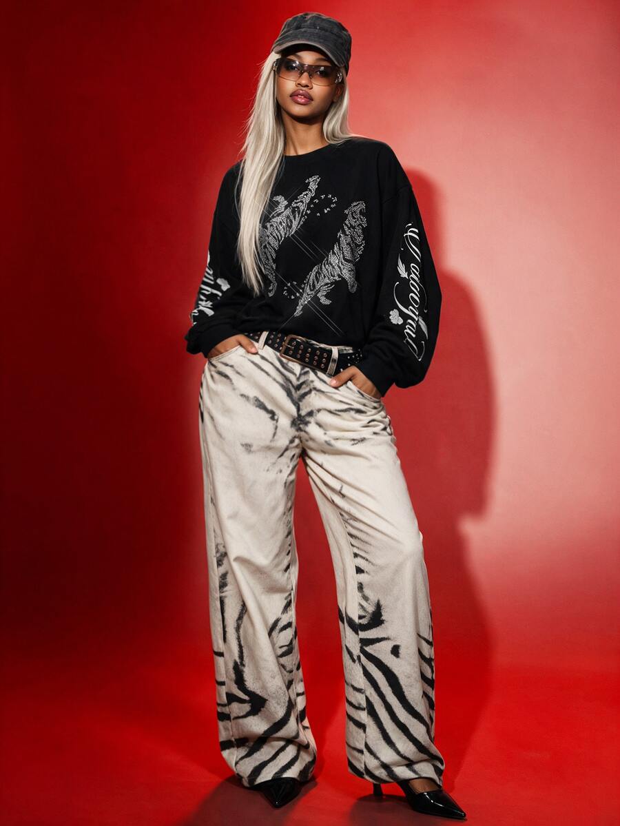 Women's white oversized long sleeve graphic T-shirt with drop shoulders and a round neckline.